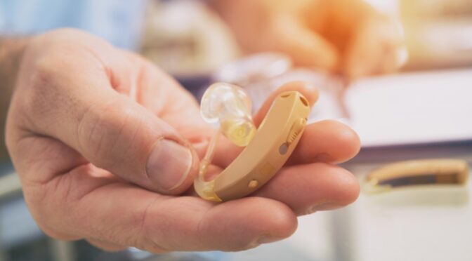 picture of person holding hearing aids offered by platinum hearing aids in detroit