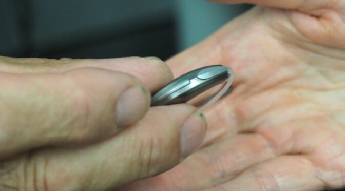 picture of person holding hearing aids from platinum hearing aids in detroit
