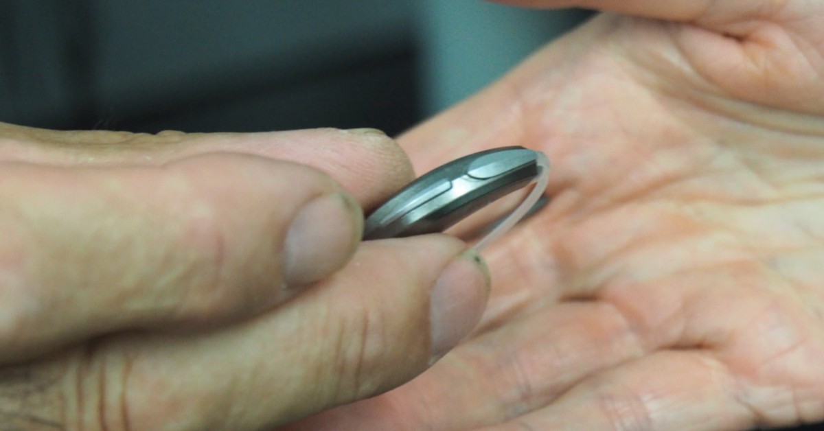 picture of person holding hearing aids from platinum hearing aids in detroit