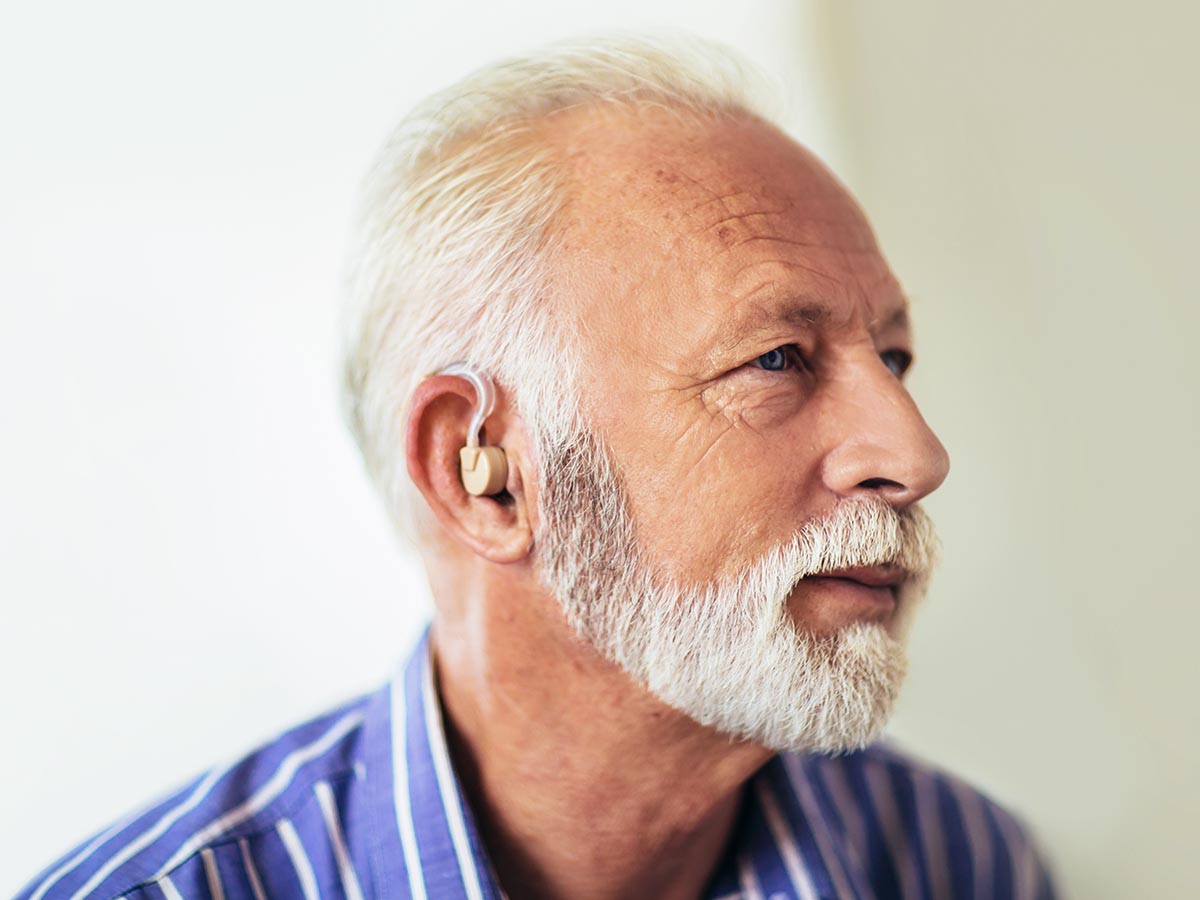 Elderly man wearing a hearing aid